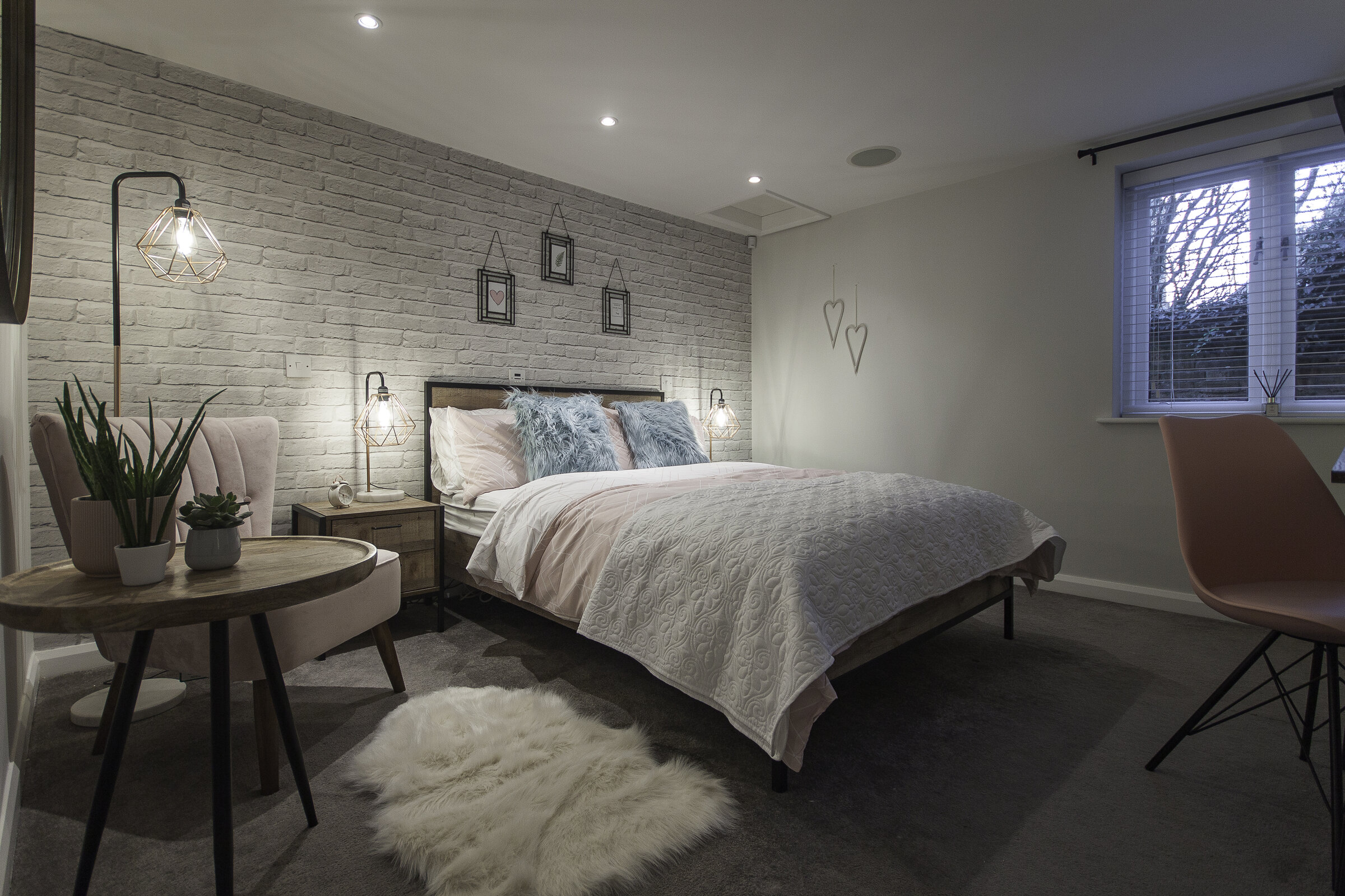 Softly textured stone, grained timber and layered rugs in a 2026 interior