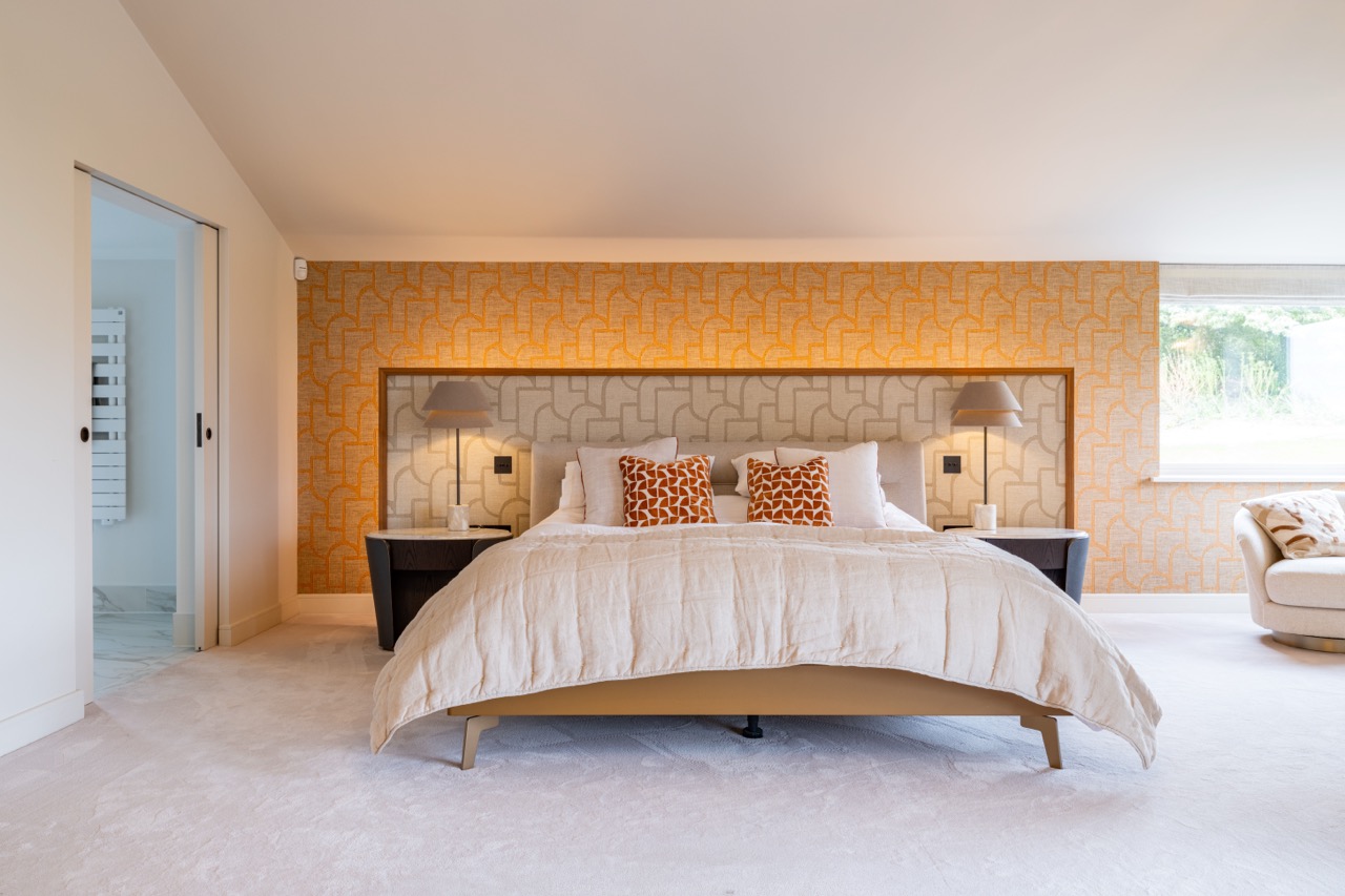 Queens Orchard master bedroom with geometric feature wallpaper and ensuite