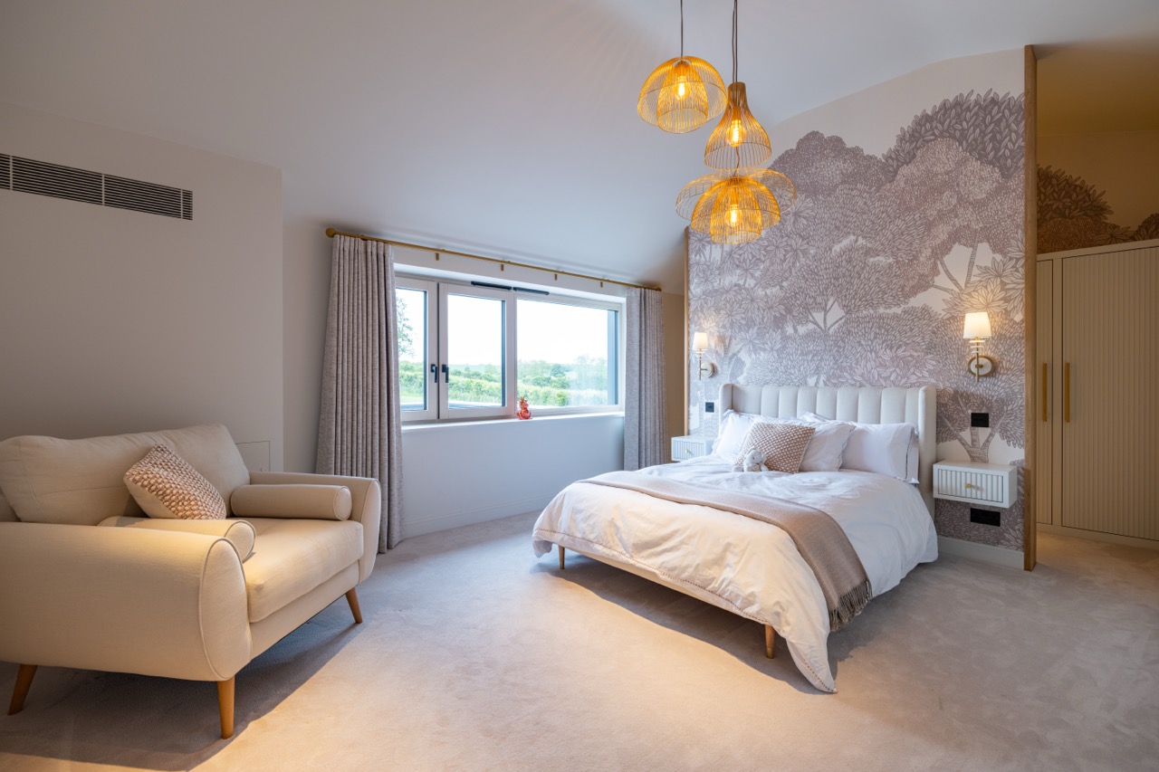 Queens Orchard guest bedroom with botanical mural and rattan pendant lights