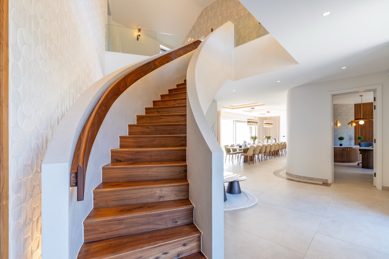 Queens Orchard grand walnut staircase leading through to the dining room