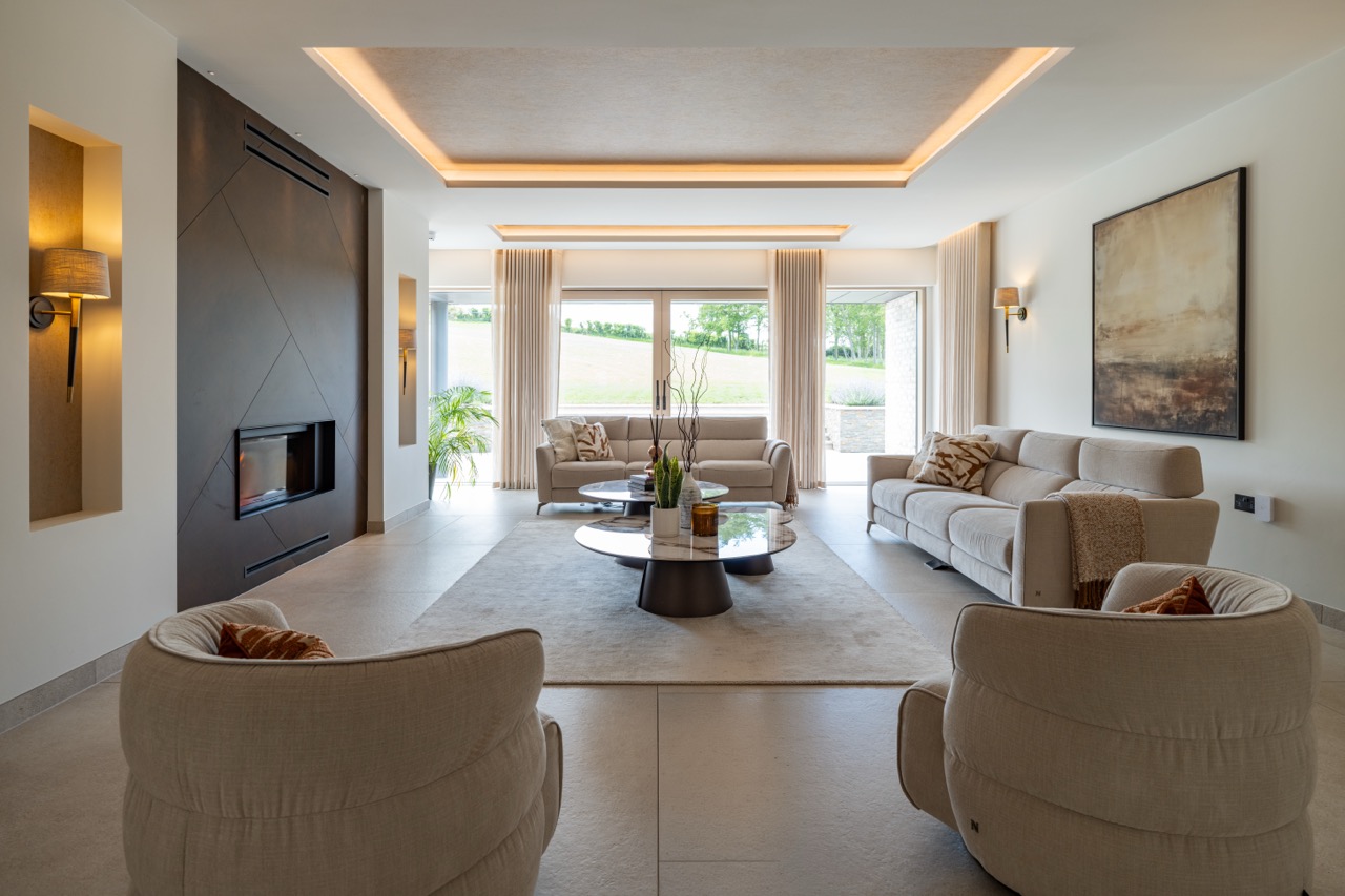 Queens Orchard living room with bronze fireplace and garden views