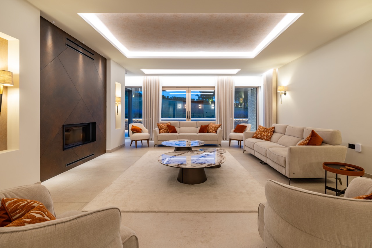 Queens Orchard living room at dusk with twin marble coffee tables