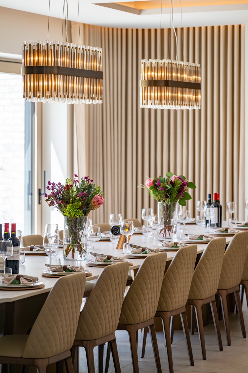 Queens Orchard dining table detail with floral centrepieces
